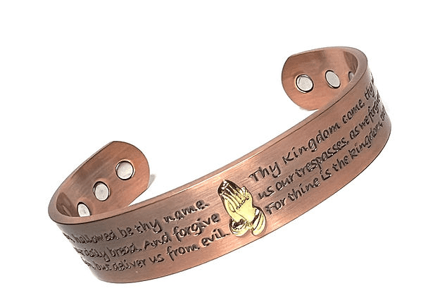 A copper bracelet with the words " thy kingdom come ".