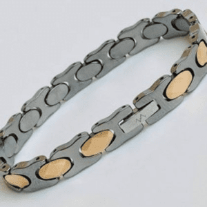 A bracelet that is made of metal and has gold accents.