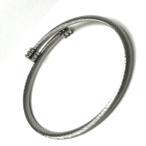 A silver bracelet with a small metal tube.