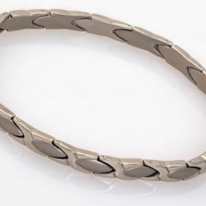 A silver bracelet with a pattern of hearts.