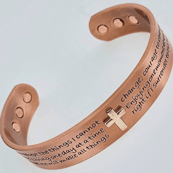 A copper bracelet with the words " i cannot change things."